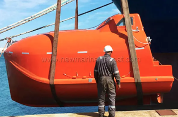 How does a free-fall lifeboat ensure the safety of its occupants during launching?